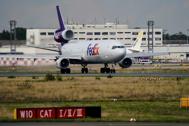 FedEx Express cargo airplane on a runway at an airport